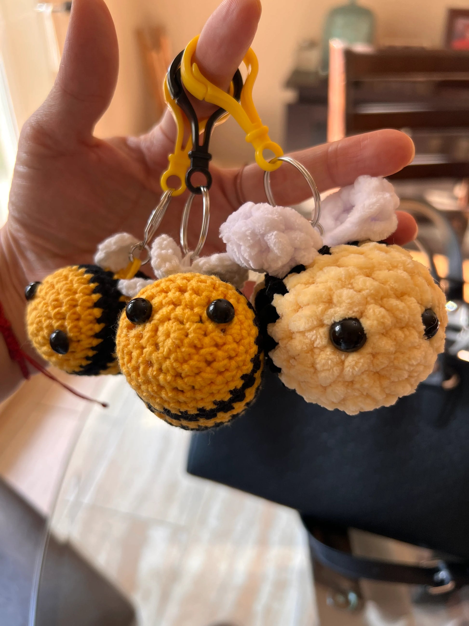 Front view of the keychain bee plushies grouped together