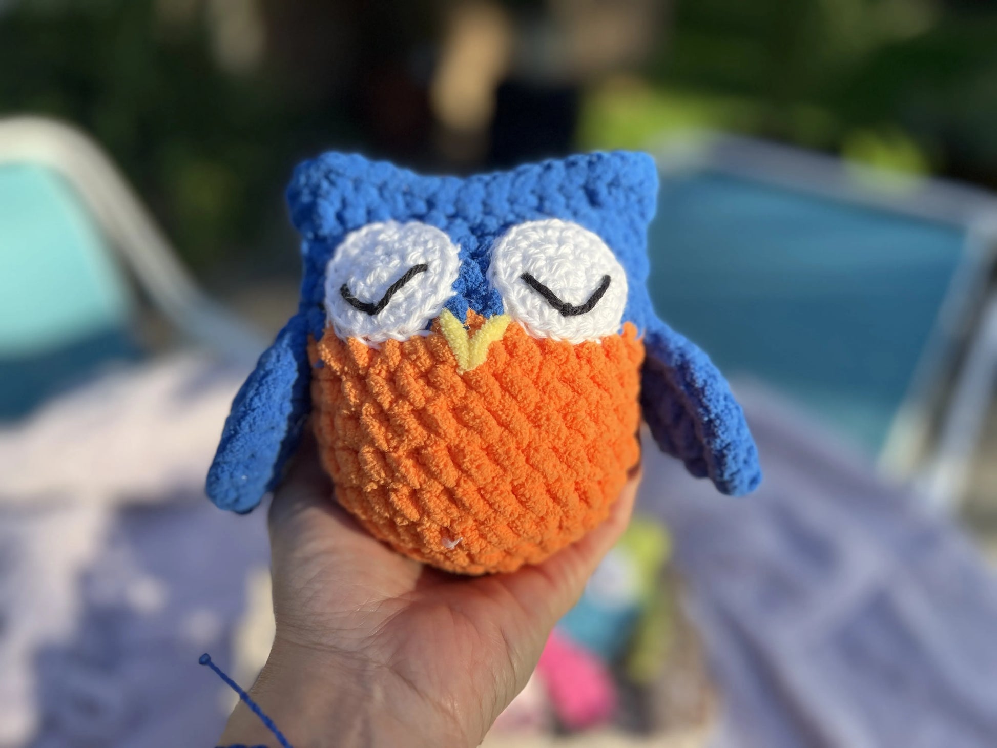 Front view of the blue and orange owl plushie