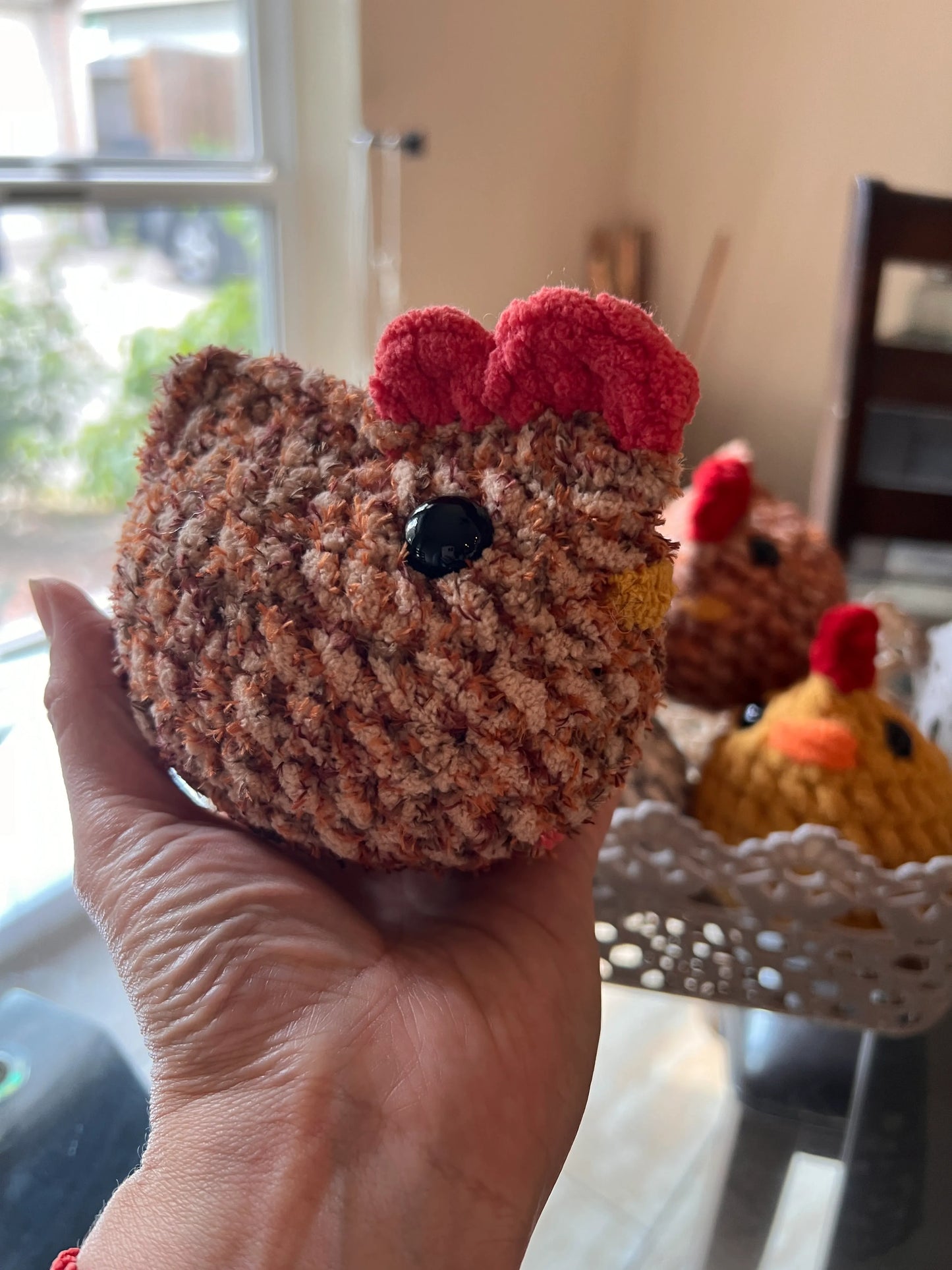 Side profile view of a brown mixed chicken plushie