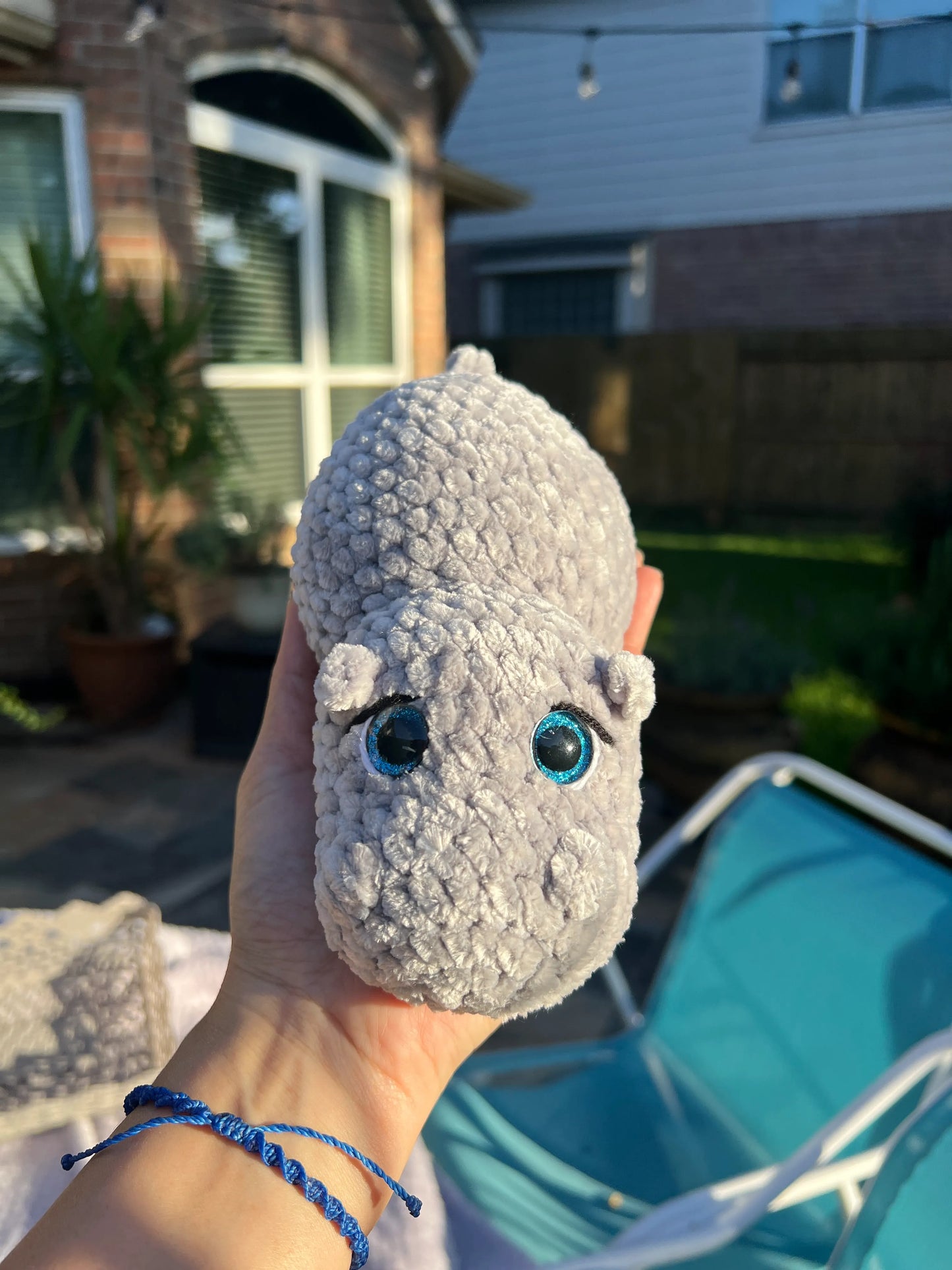 Front view of the gray hippo plushie