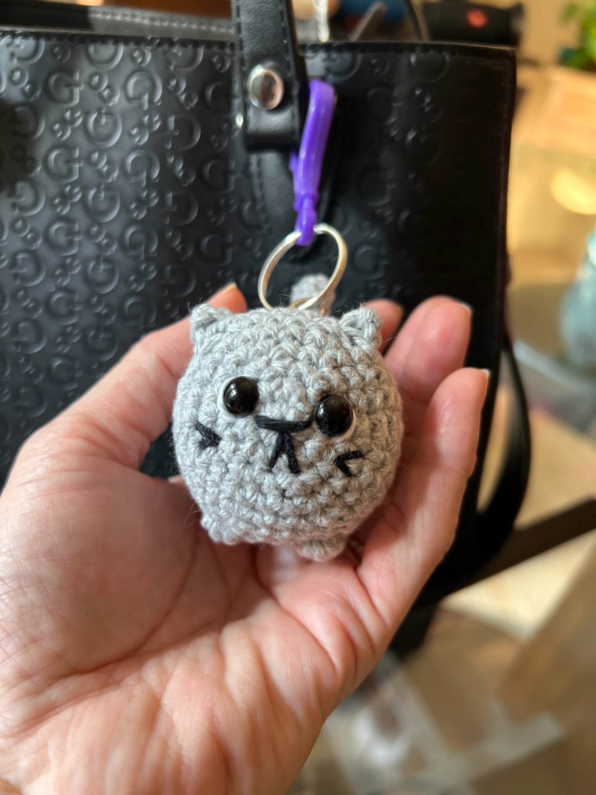 Front view of the gray keychain plushie