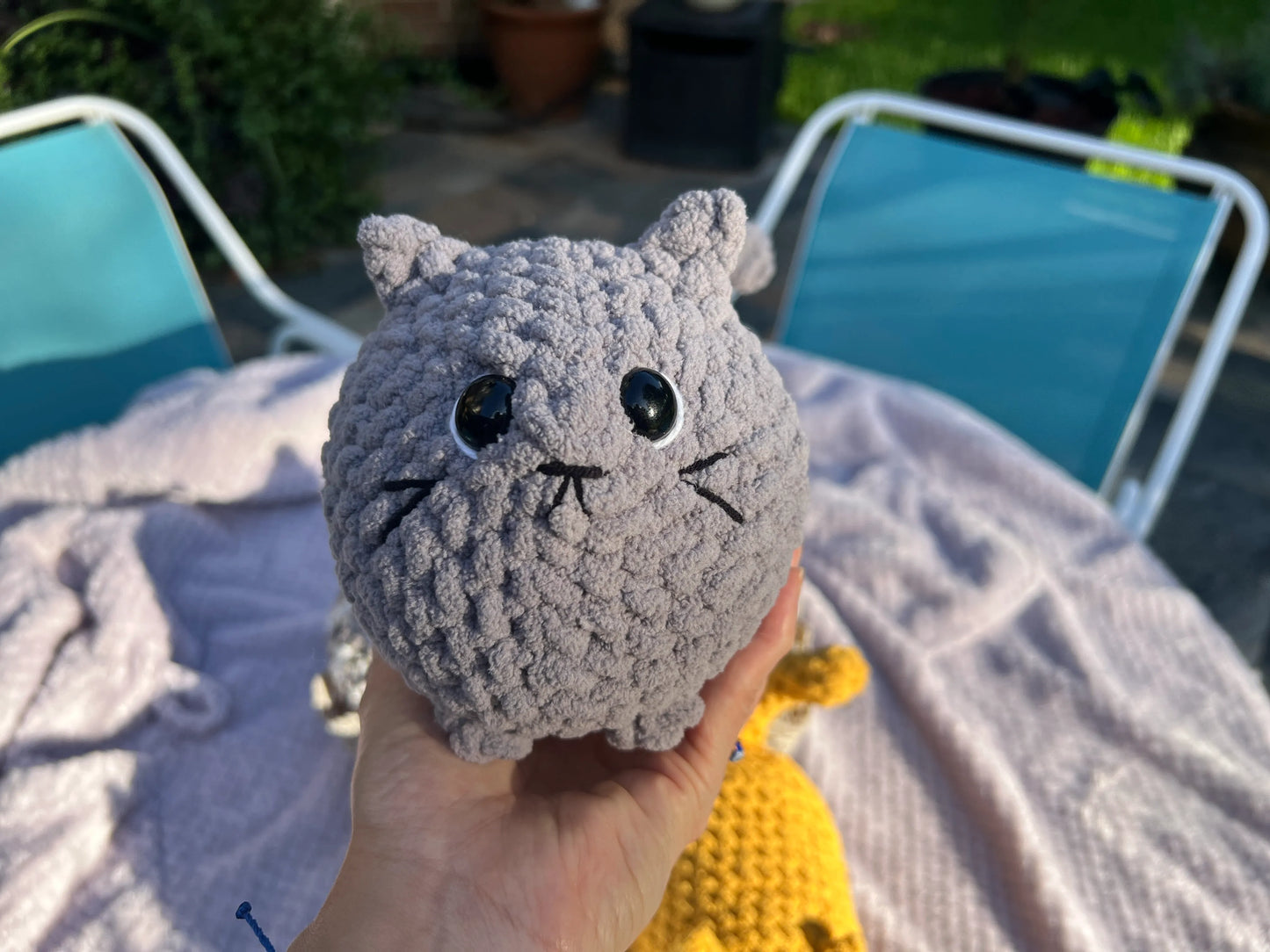 Front view of the gray loaf cat plushie