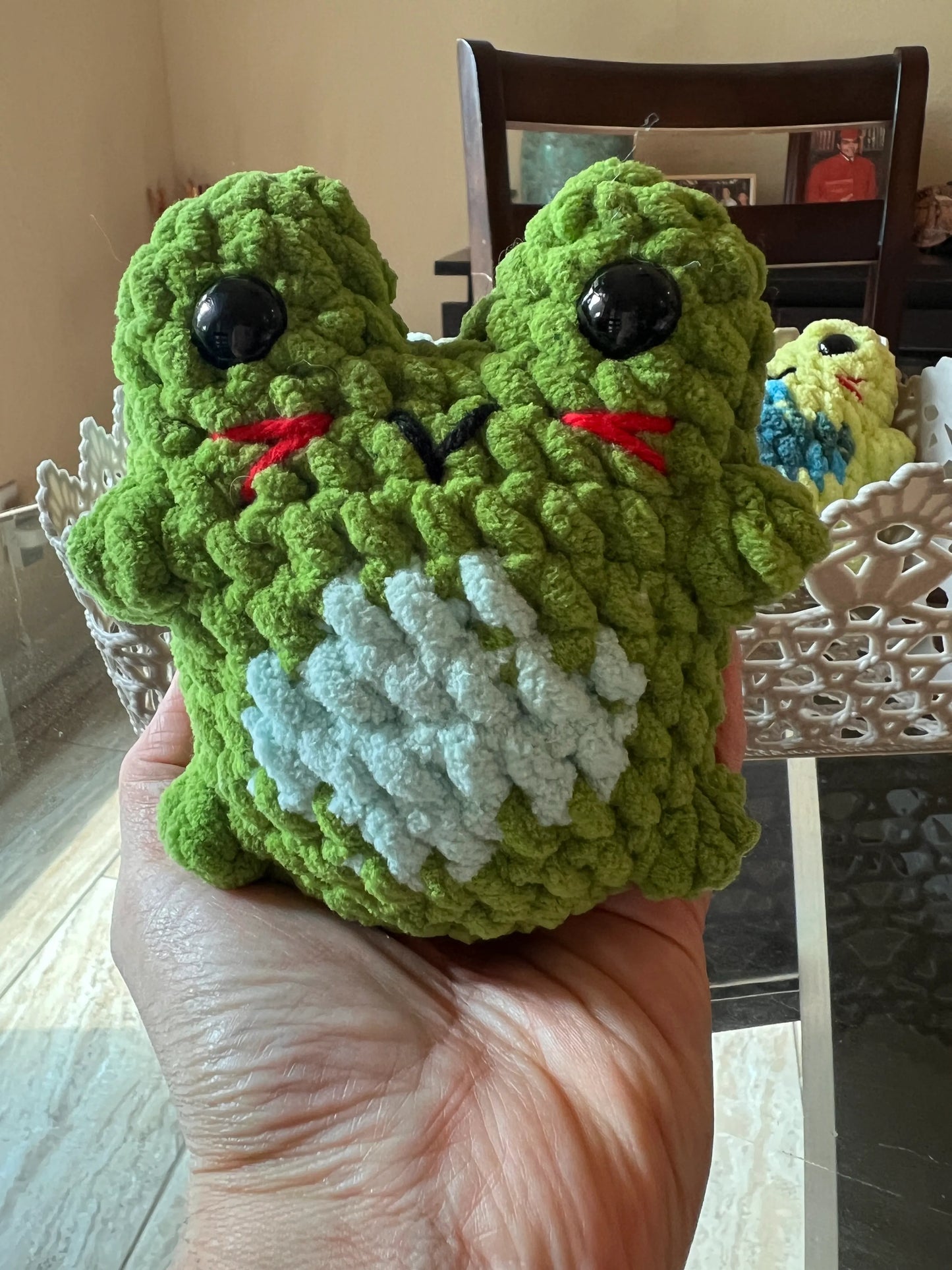 Front view of the green frog plushie