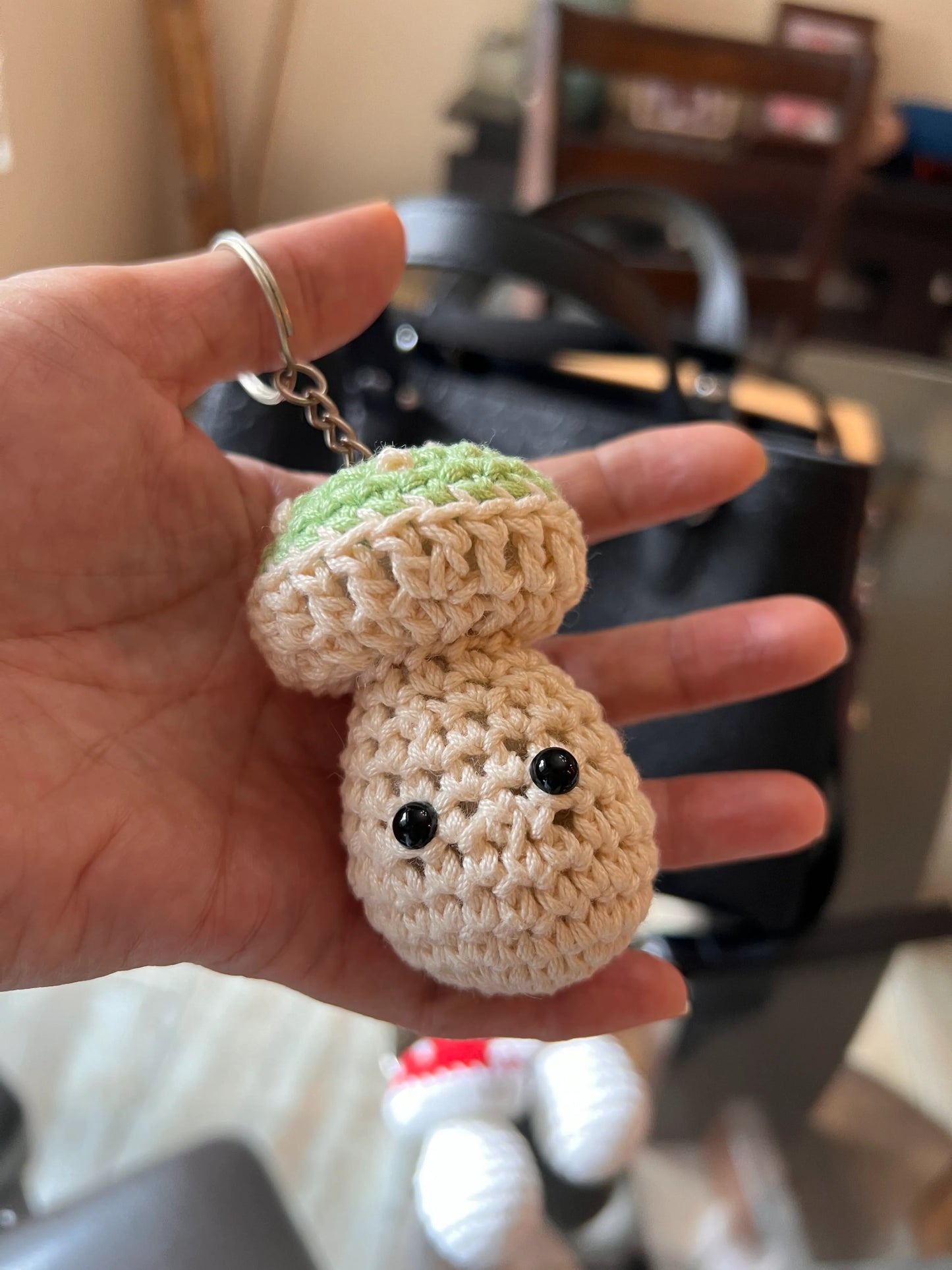 Front view of the green mushroom keychain plushie