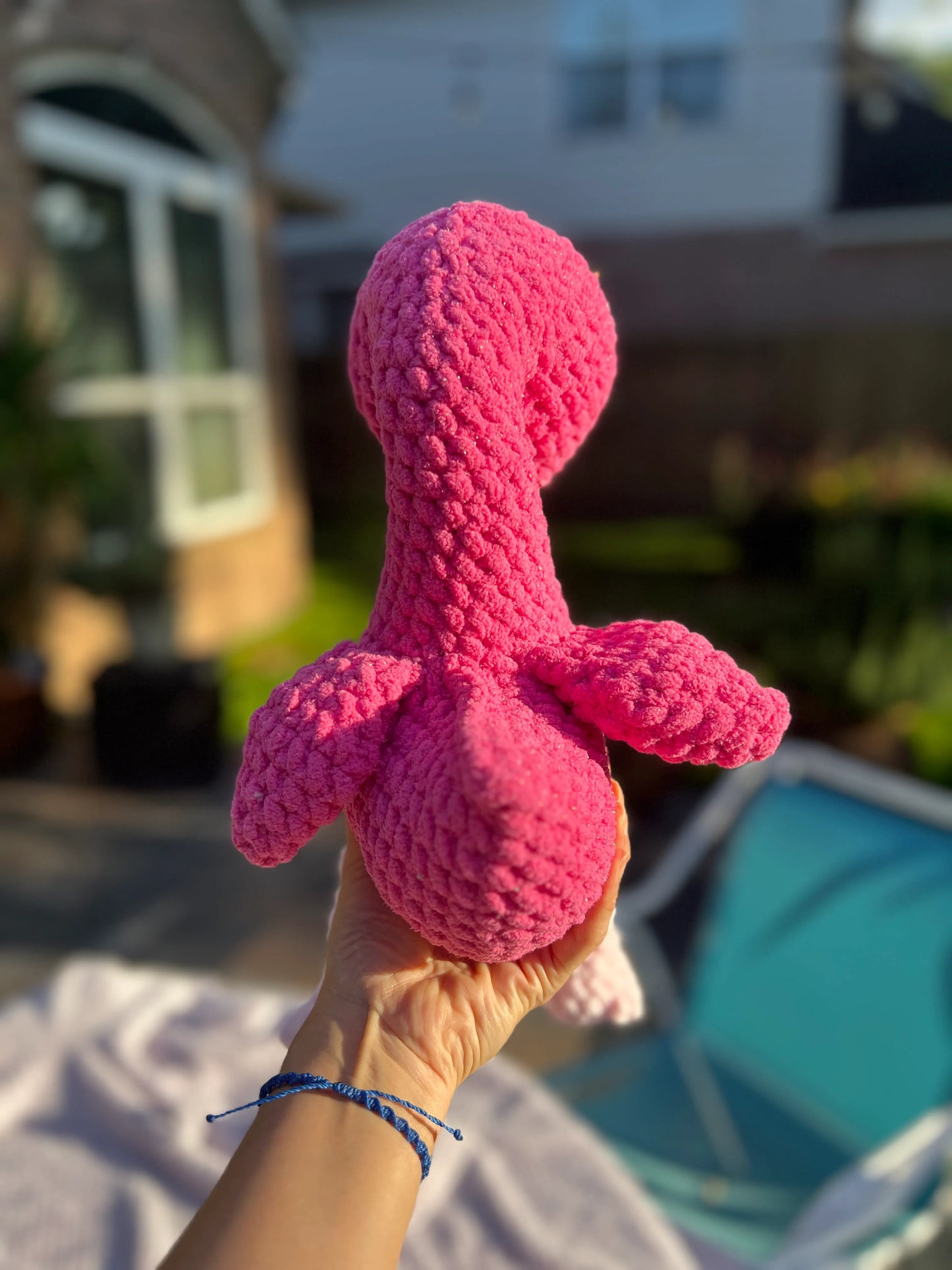 Backside view of the hot pink flamingo plushie