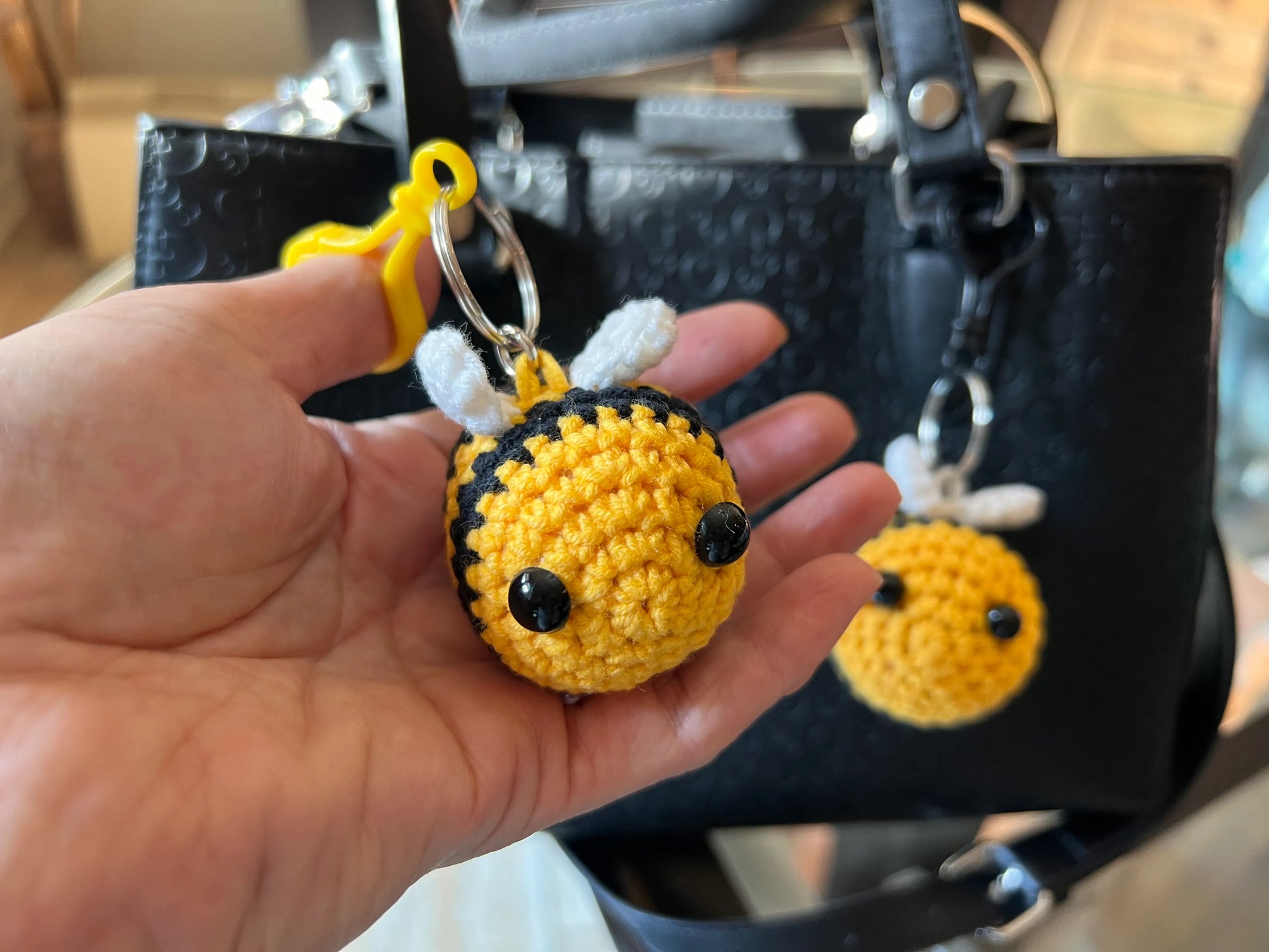 Front view of a keychain bee plushie