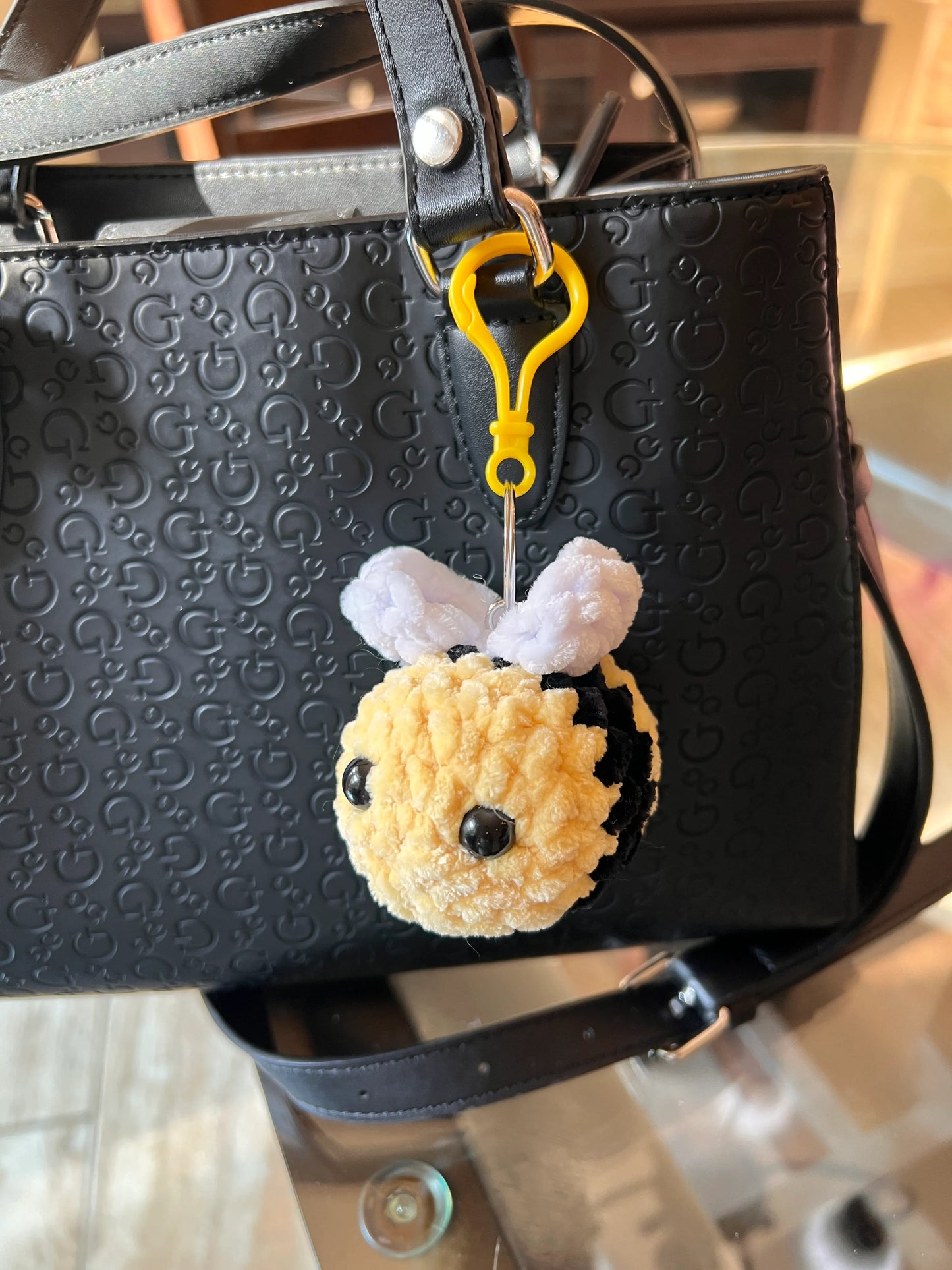 Front view of a keychain bee plushie