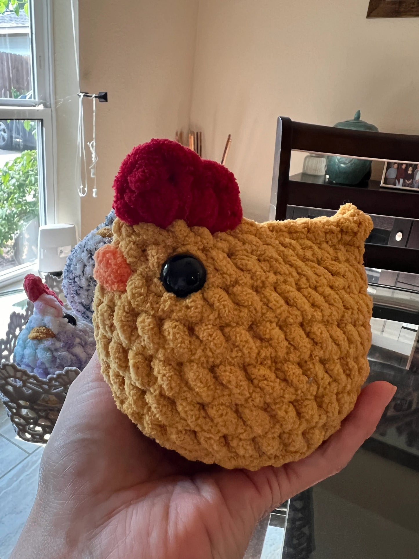 Front view of a brown chicken plushie