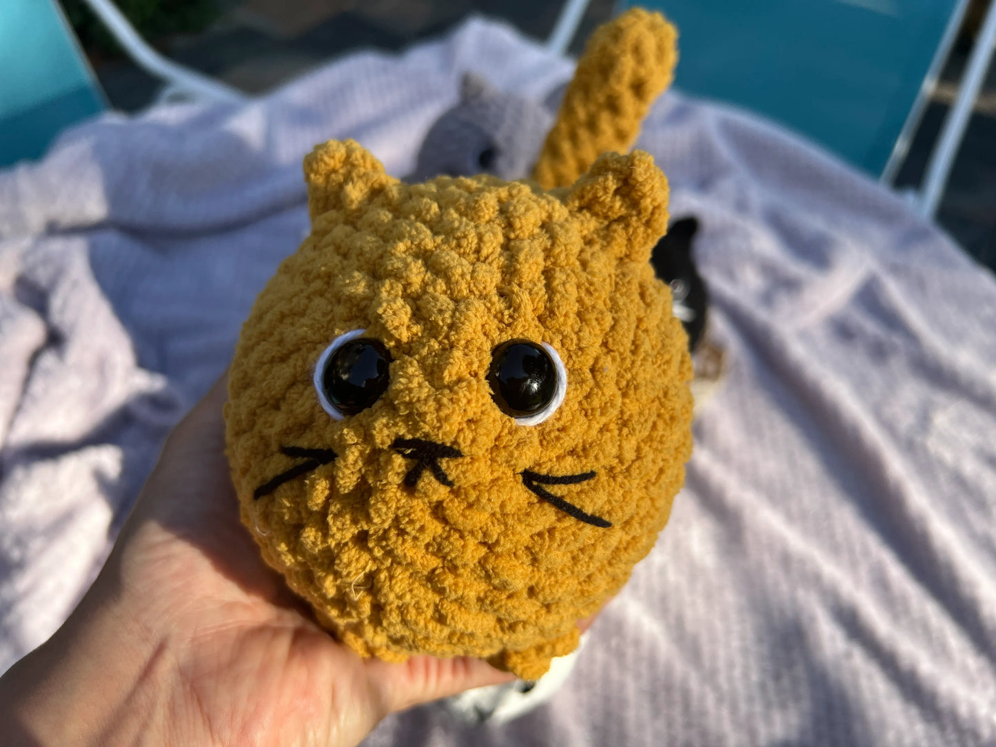 Front view of the orange loaf cat plushie