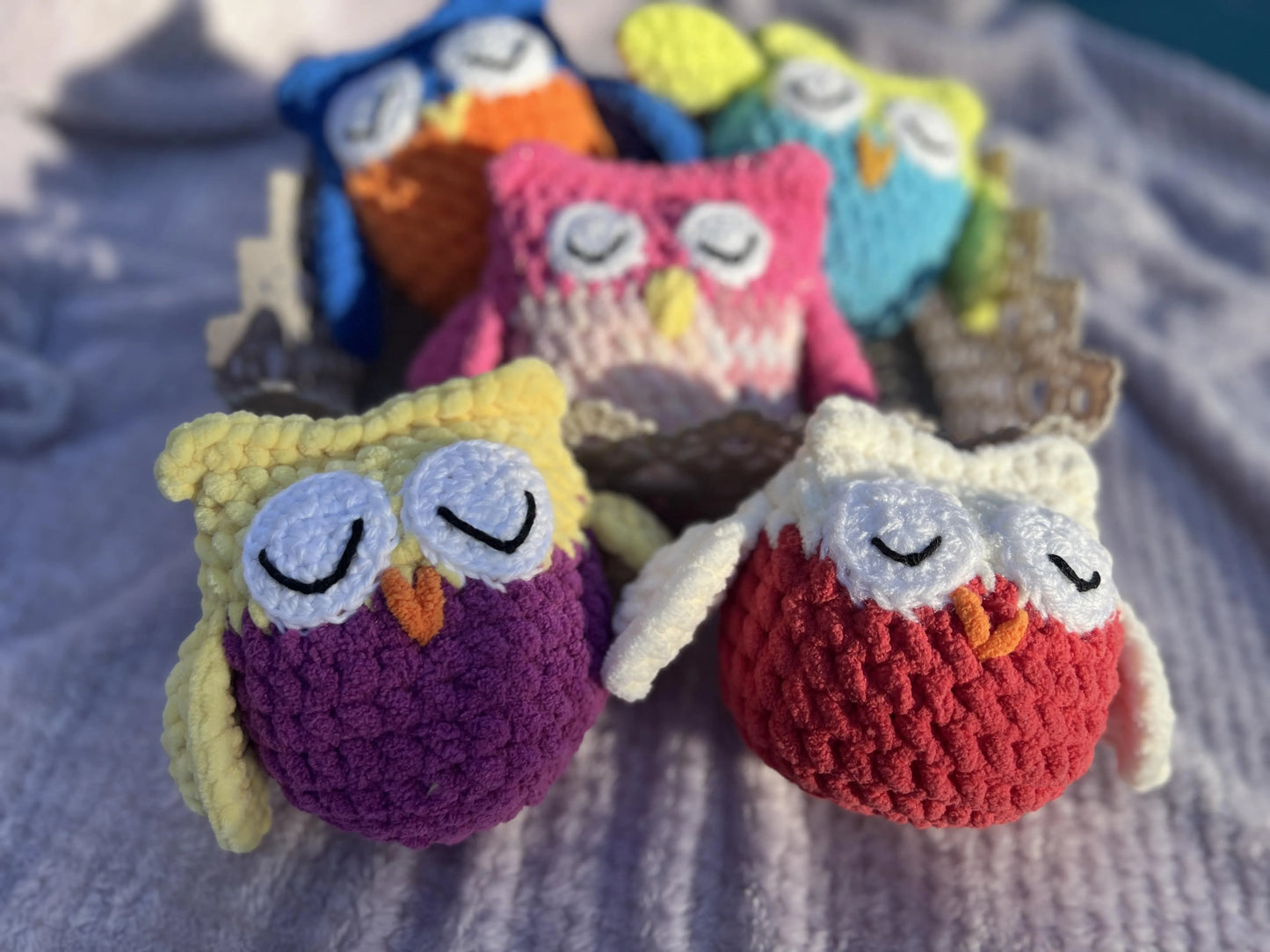 Front view of the owl plushies grouped together