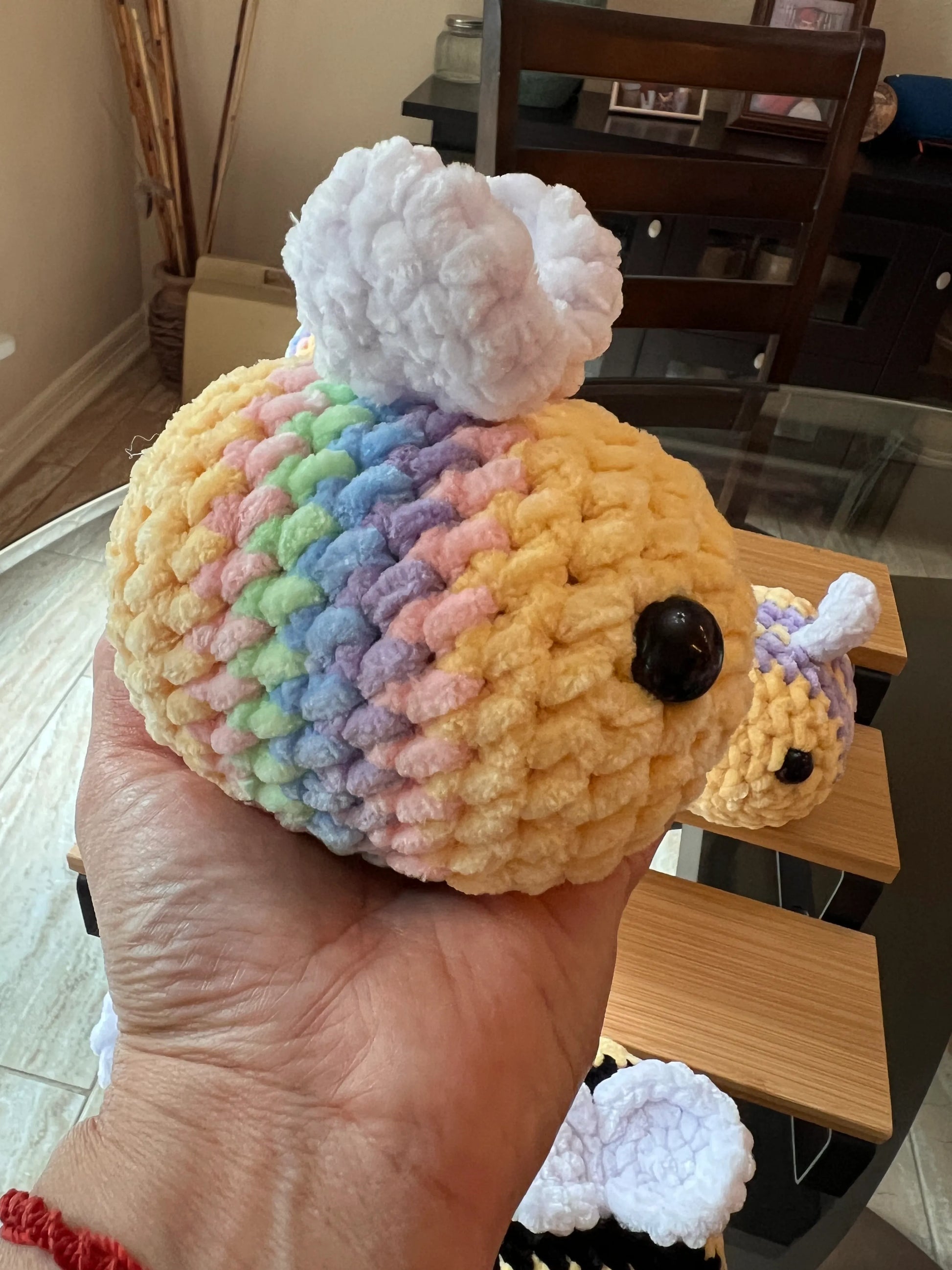 Side profile view of a pastel mix bee plushie