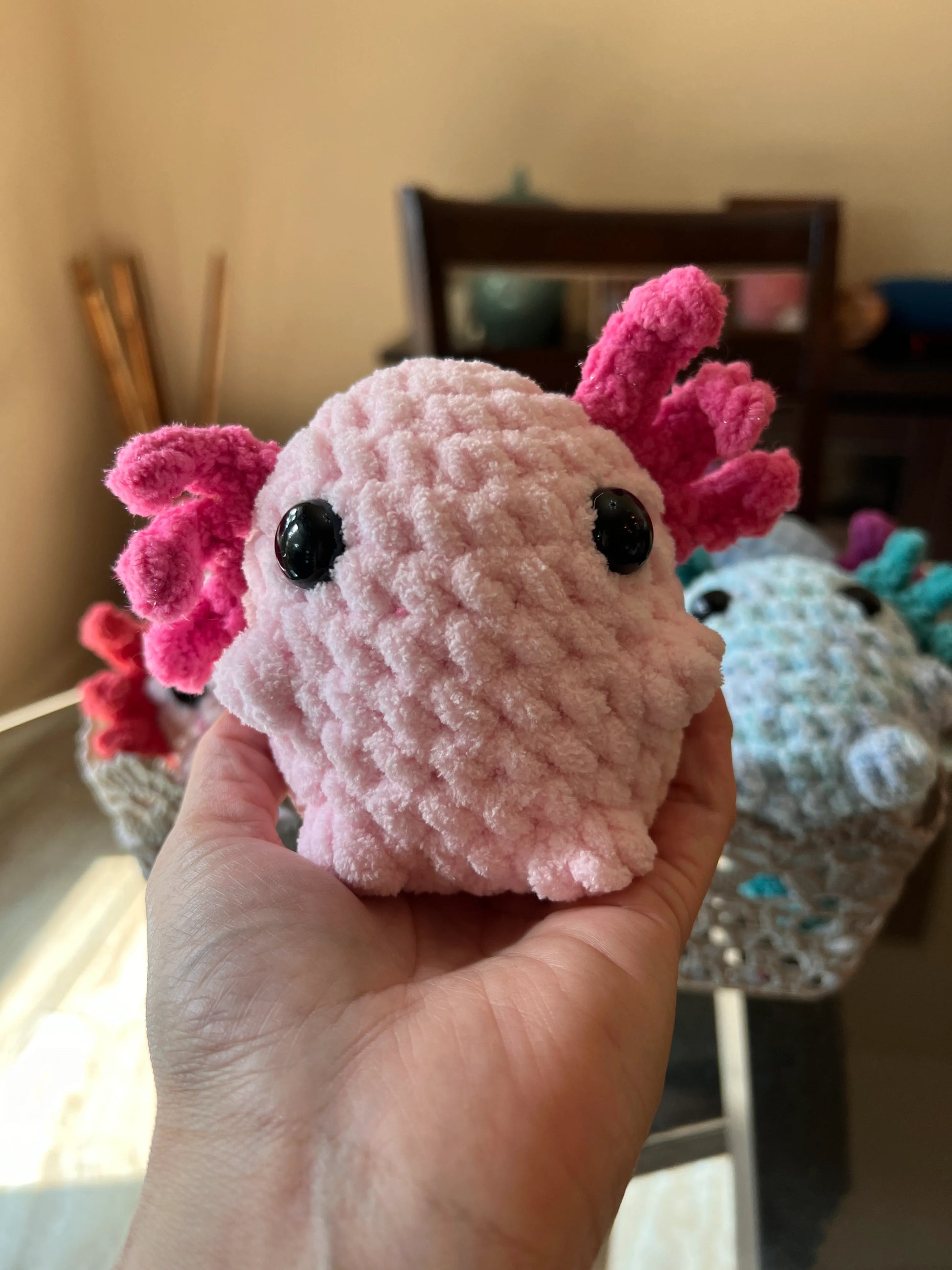 Front view of the pink axolotl plushie