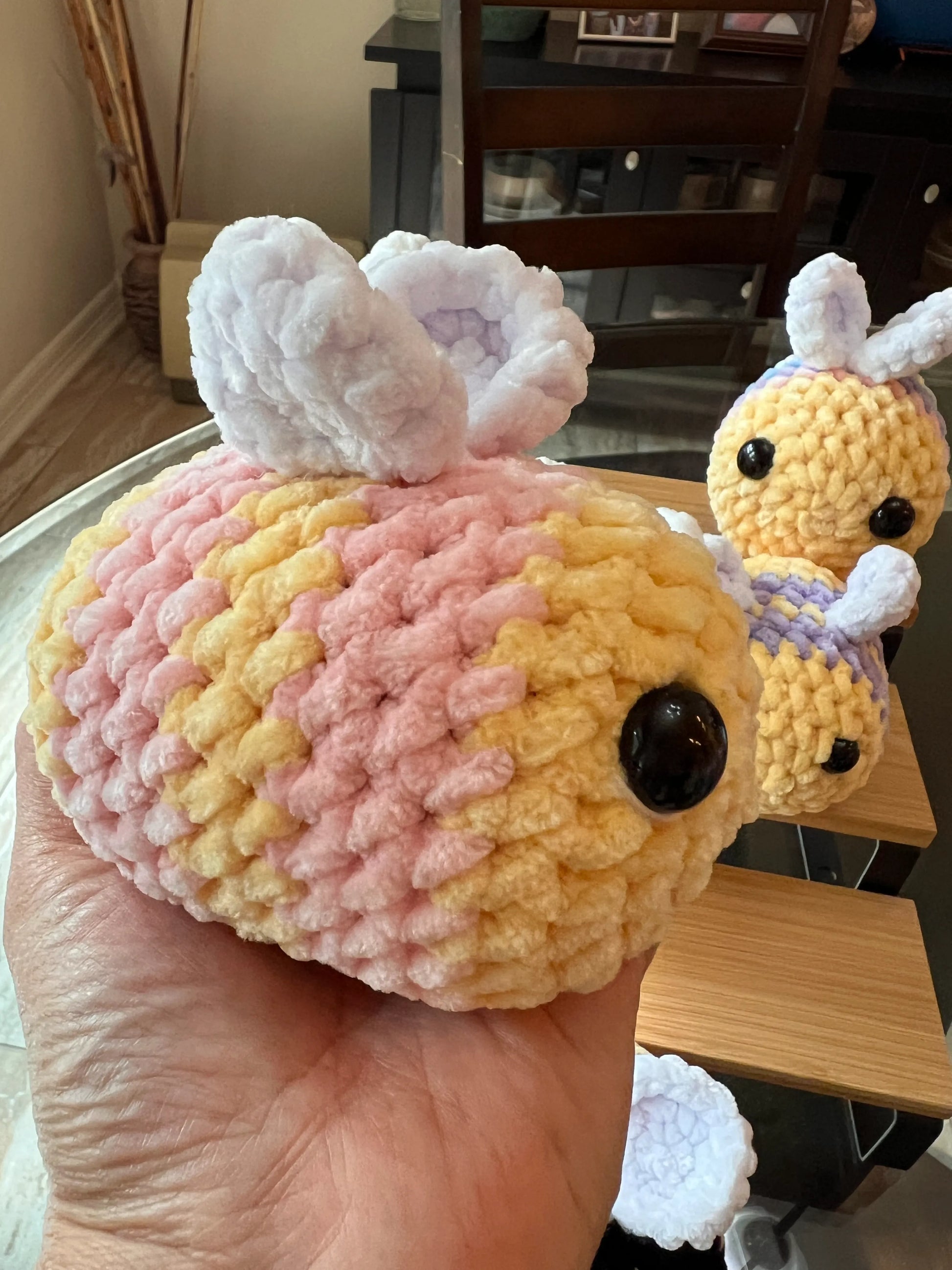 Side profile view of a pink bee plushie