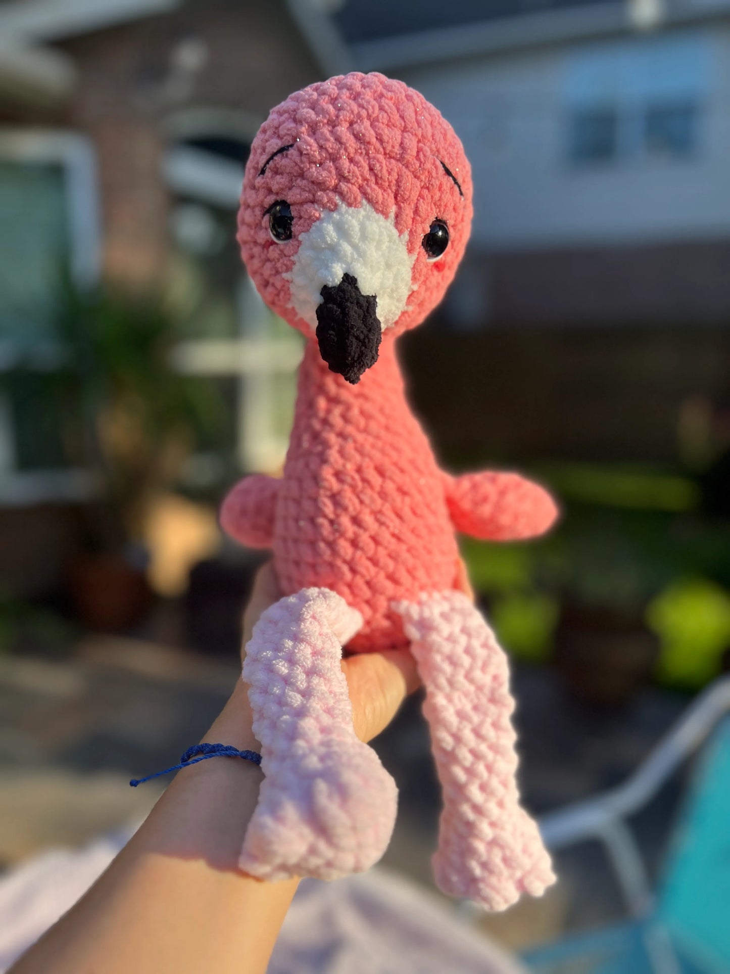 Front view of the pink flamingo plushie