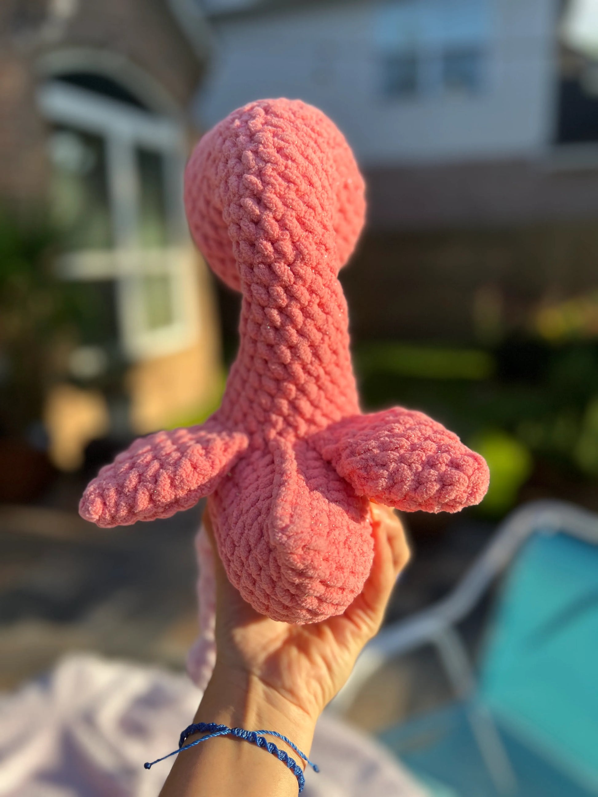 Backside view of the pink flamingo plushie