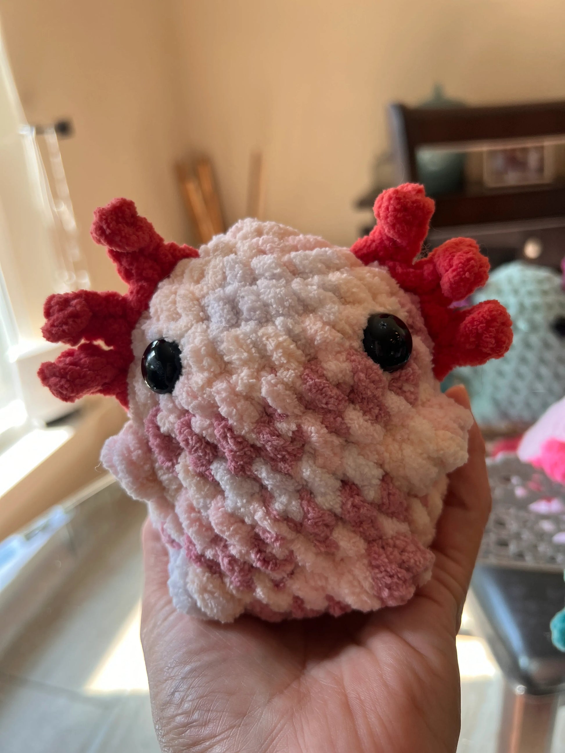 Front view of the pink mixed axolotl plushie