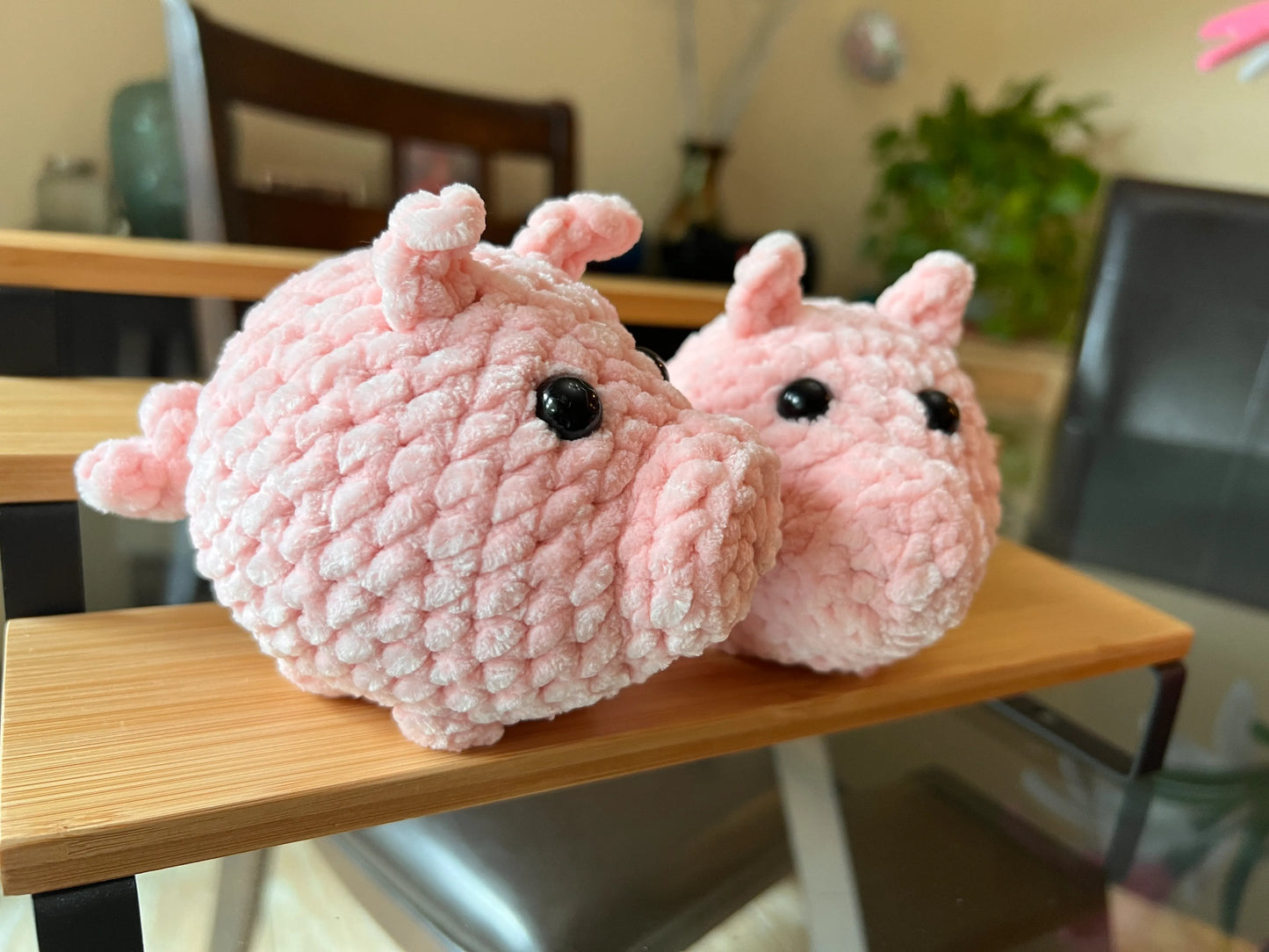 Front view of the pink pig plushies together