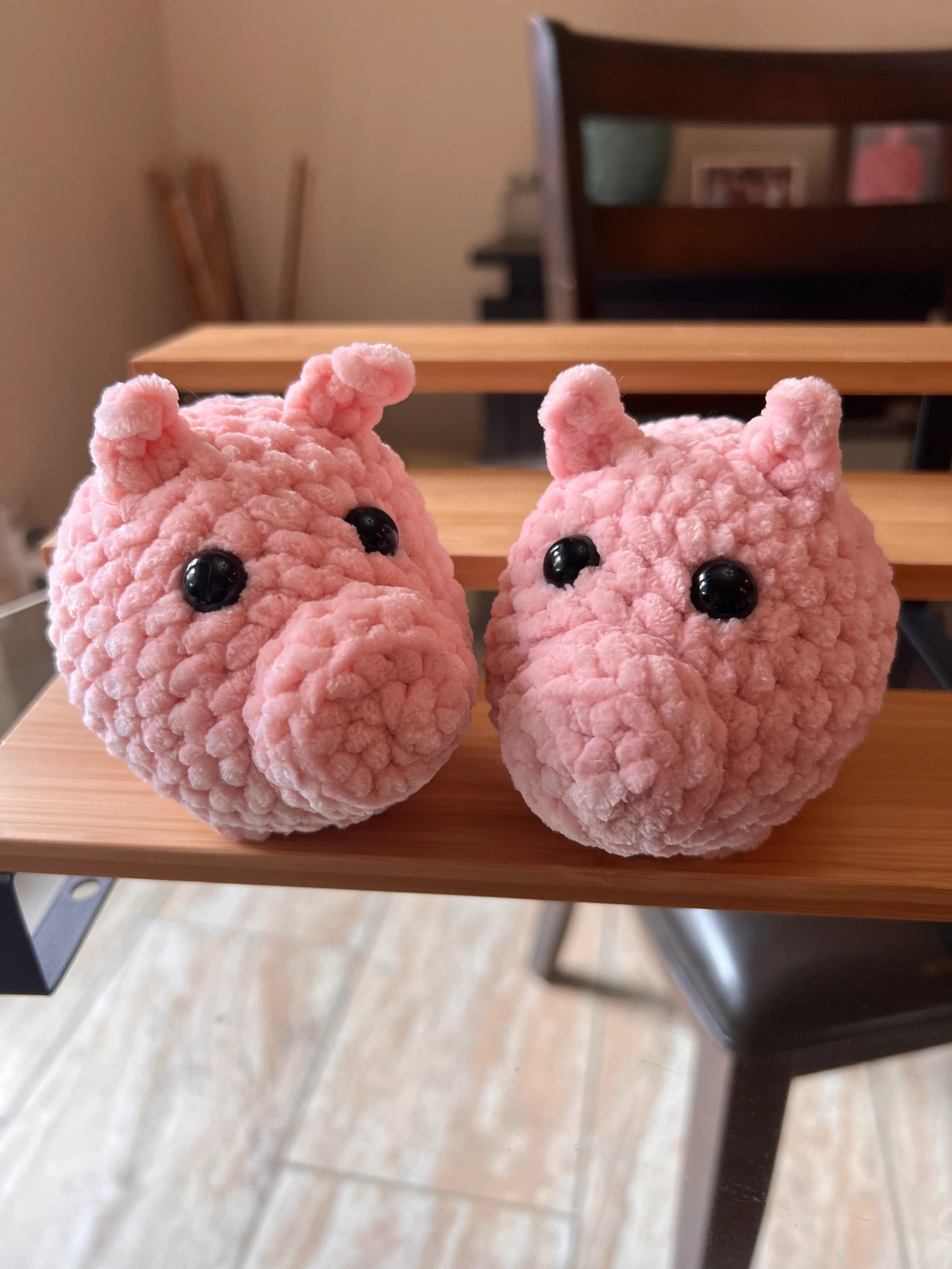 Front view of the pink pig plushies together