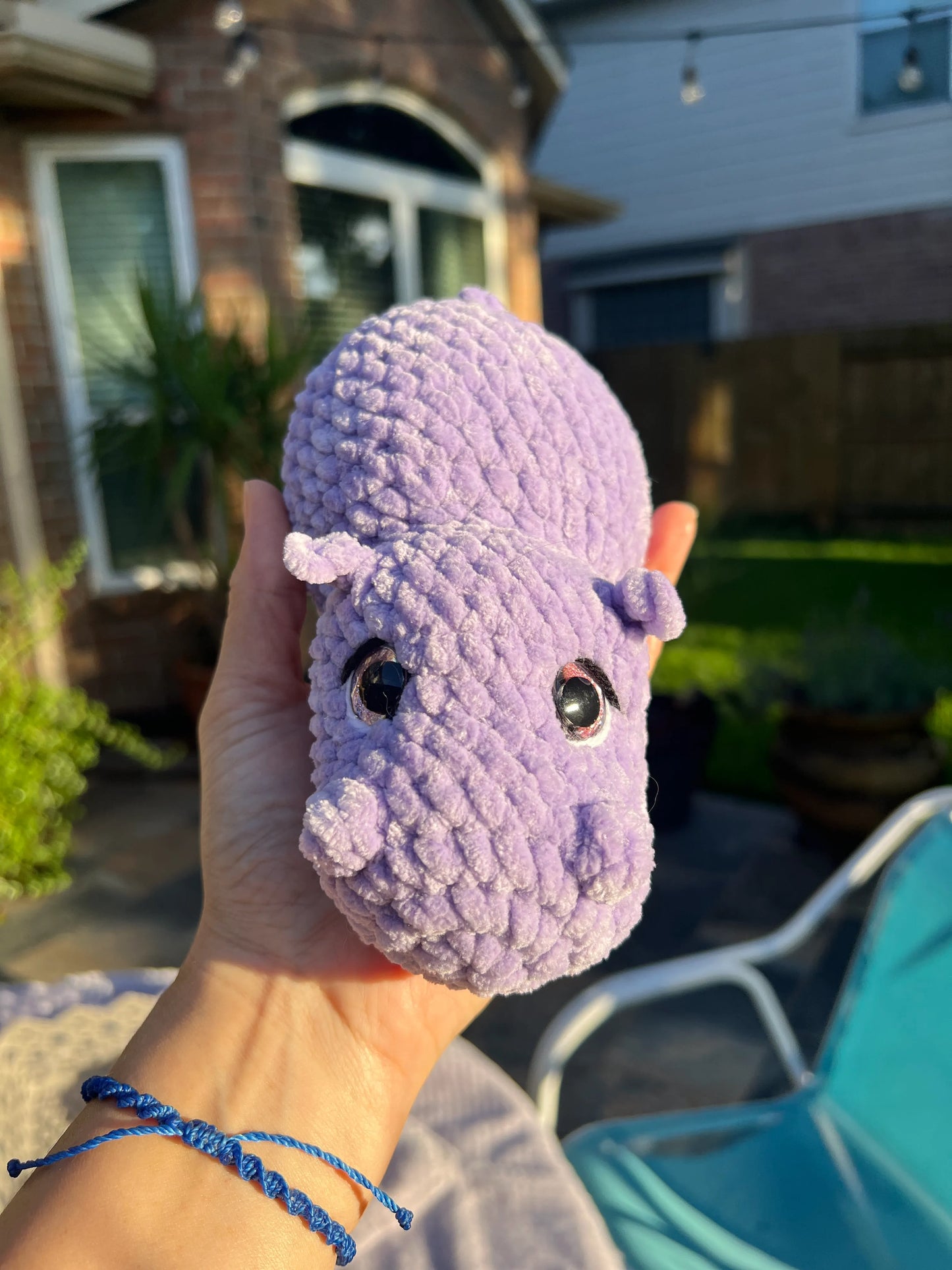 Front view of the purple hippo plushie