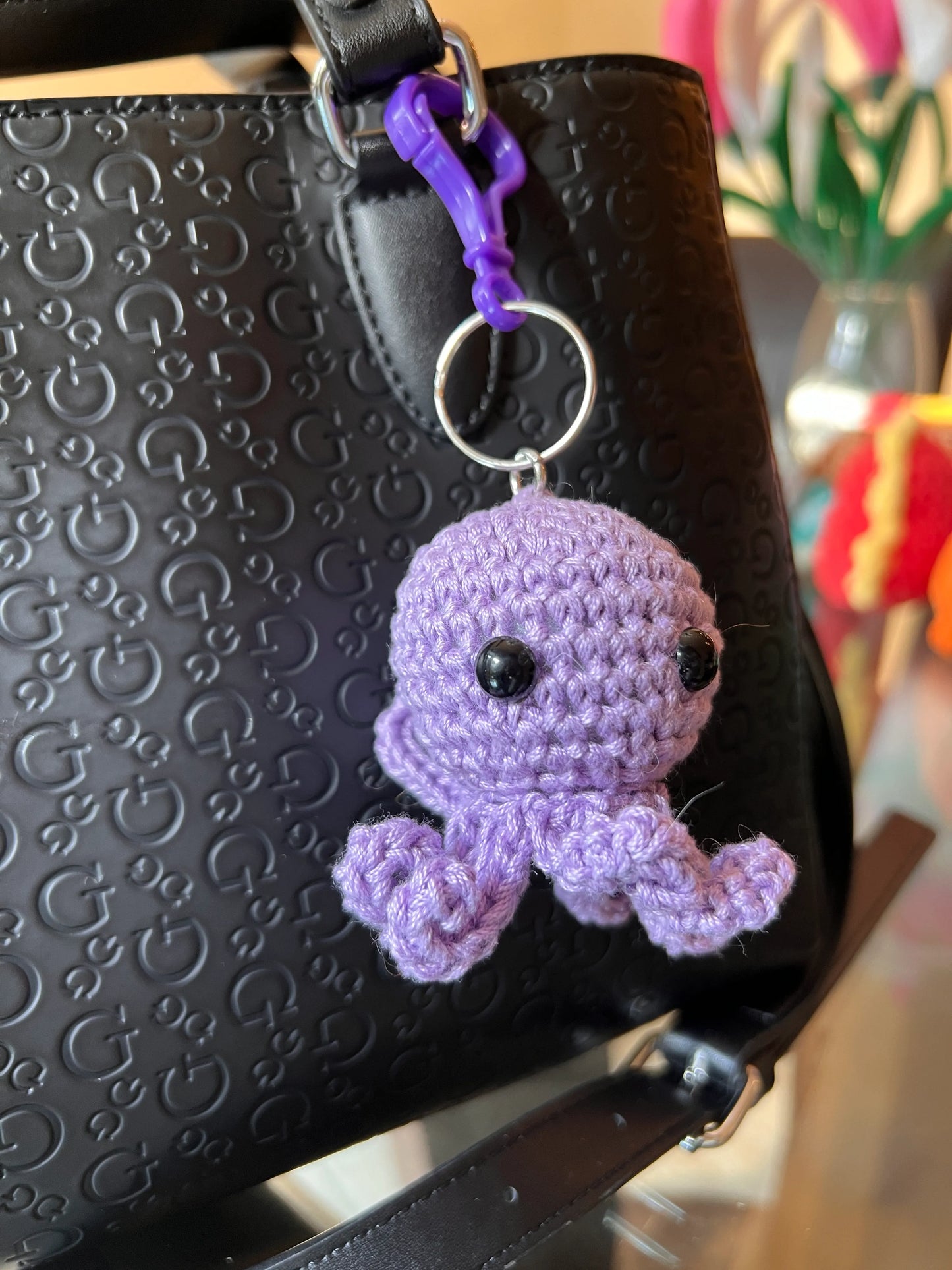 Front view of the purple octopus keychain plushie