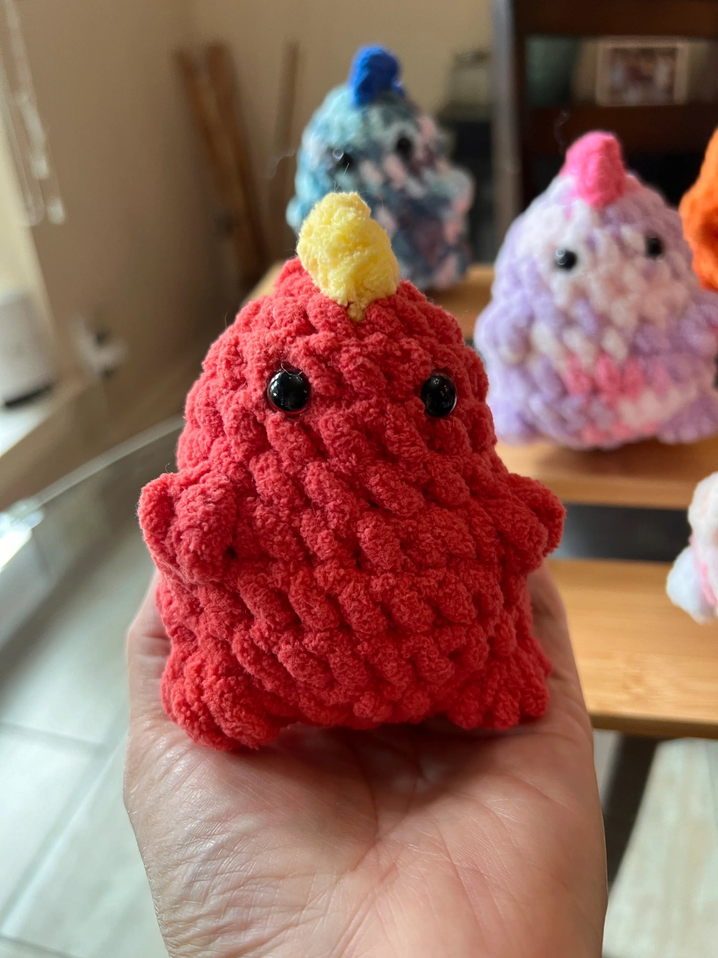 Front view of the red dinosaur plushie