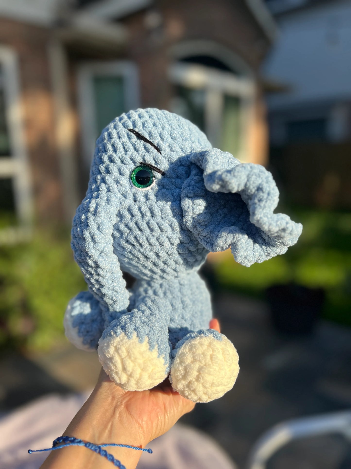 Side profile view of the sky-blue elephant plushie