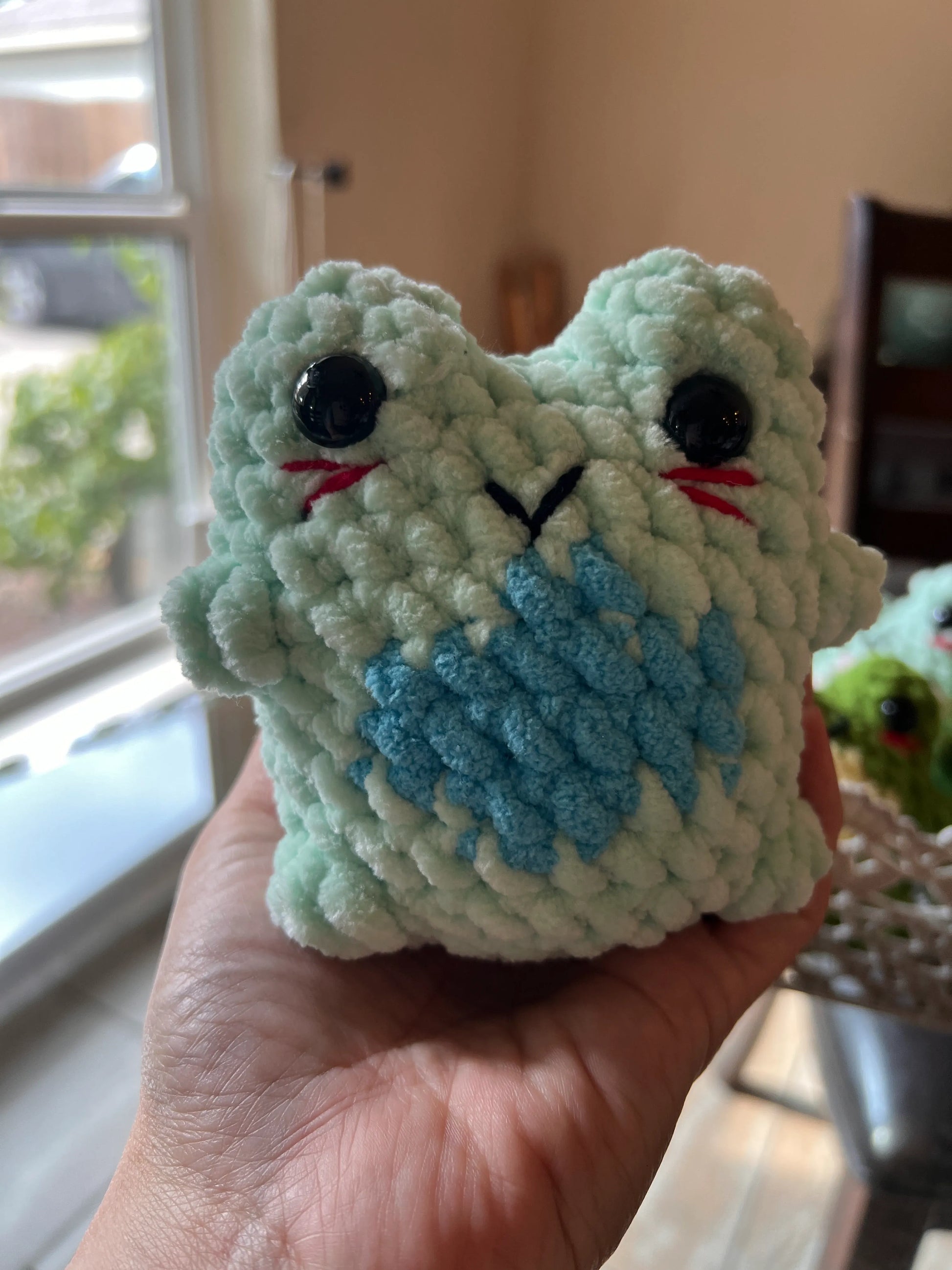 Front view of the sky-blue  frog plushie