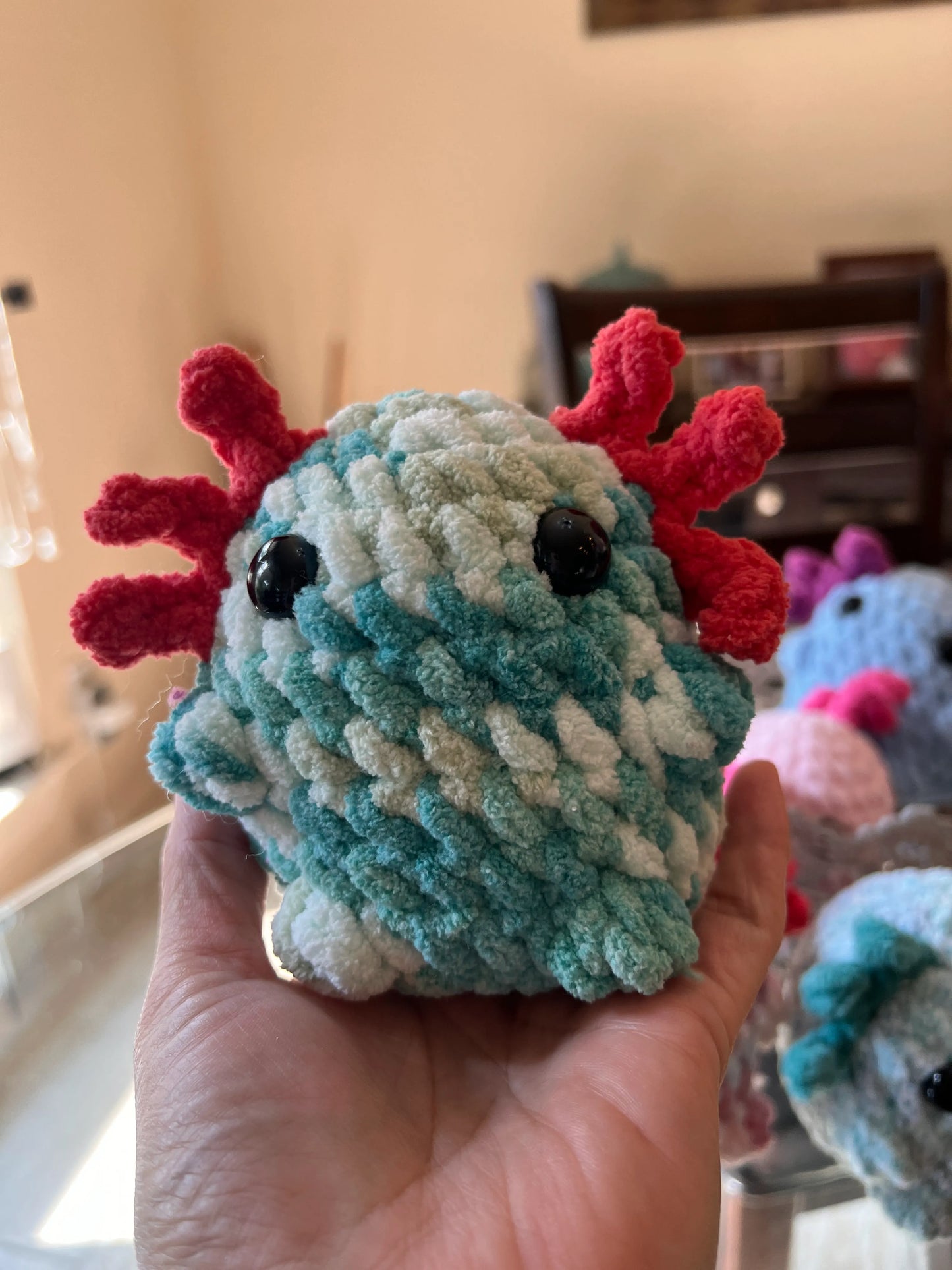 Front view of the turquoise mixed axolotl plushie