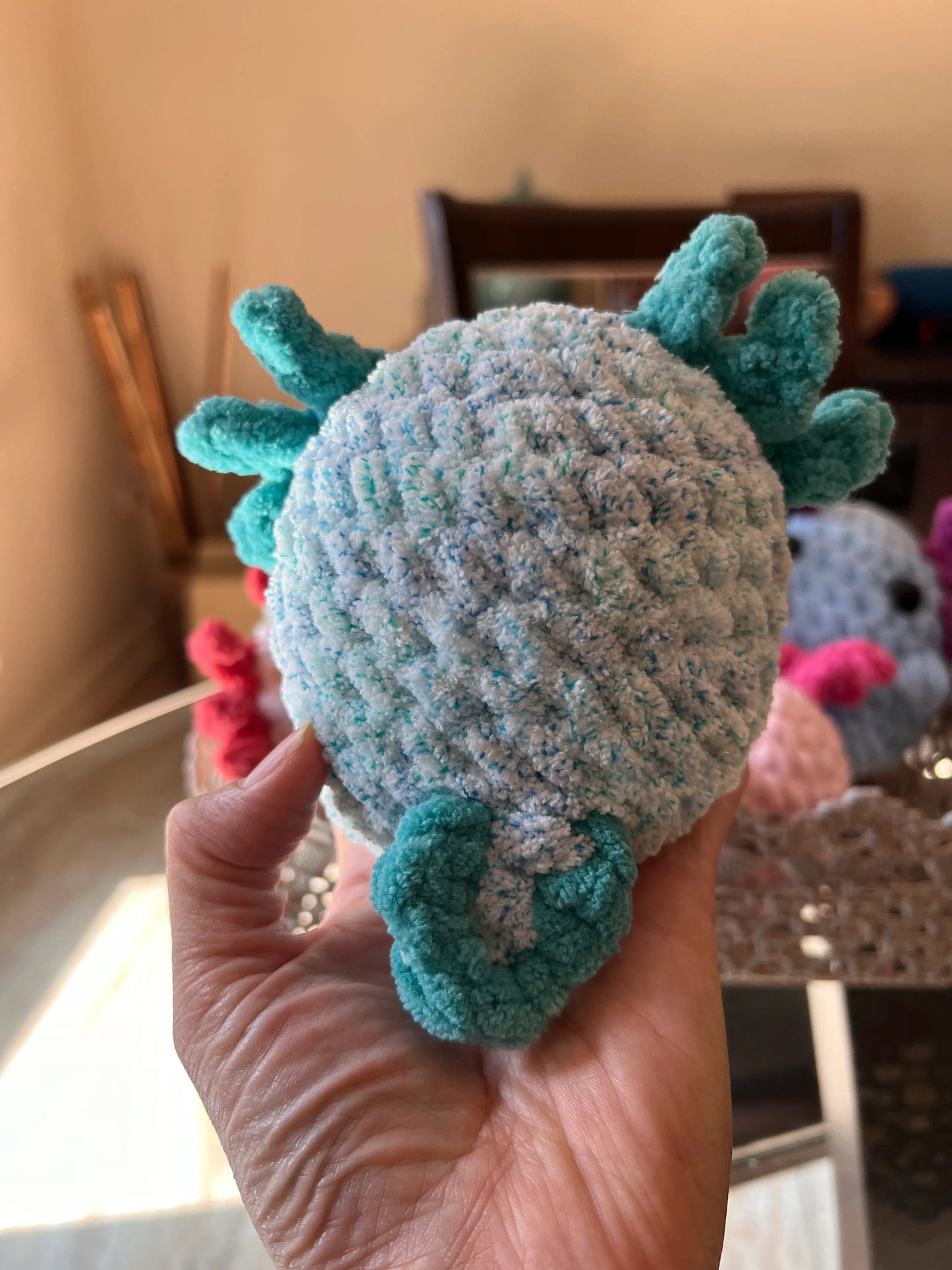 Backside view of the turquoise axolotl plushie