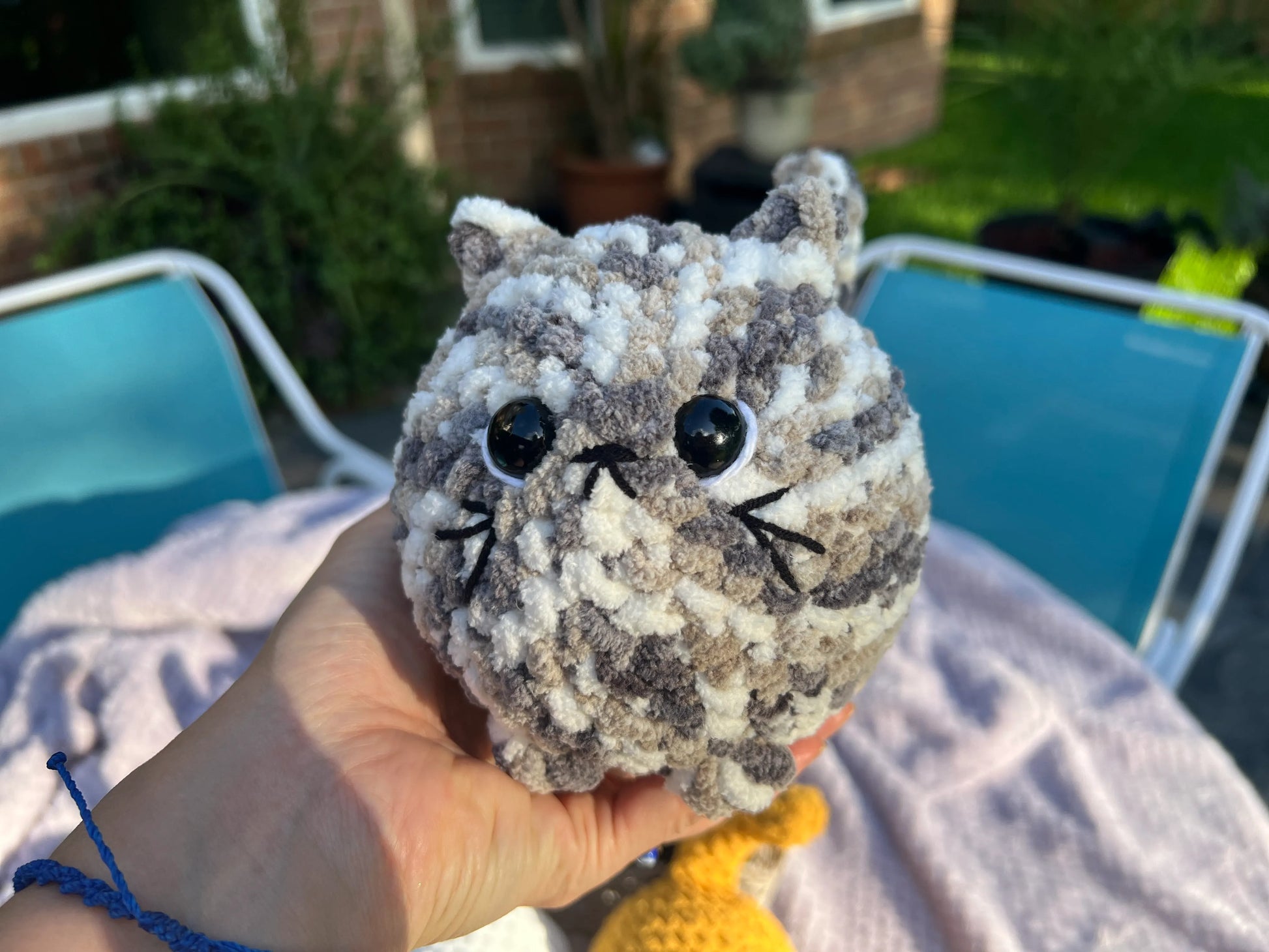 Front view of the white and gray mixed loaf cat plushie