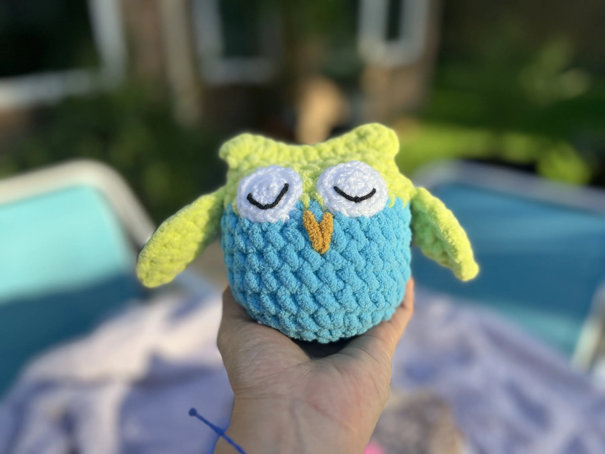 Front view of the yellow and blue owl plushie