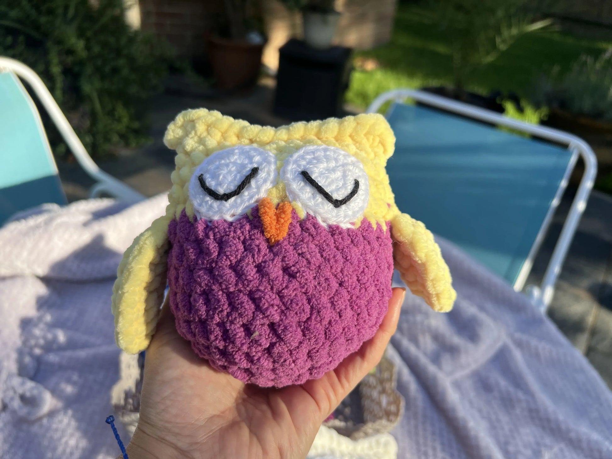 Front view of the yellow and purple owl plushie